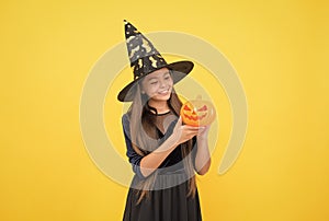 happy witch teenage girl with pumpkin jack o lantern wear costume of wizard on halloween party, halloween pumpkin
