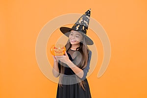 happy witch teenage girl with pumpkin jack o lantern wear costume of wizard on halloween party, halloween pumpkin