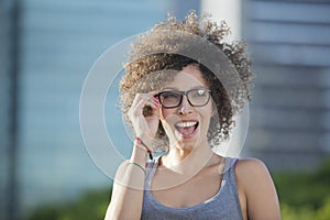 Happy woman adjusting eyeglasses