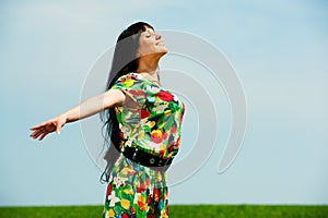 Happy woman against blue sky