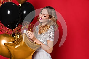 Happy woman with air balloons on red background, space for text. Christmas party
