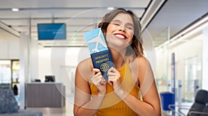 happy woman with air ticket and immunity passport