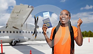 happy woman with air ticket and immunity passport