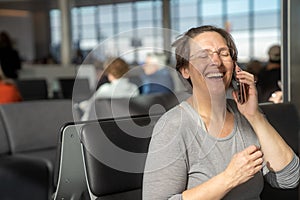 Happy woman at an airport waiting for flight