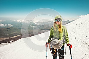 Happy Woman alpinist climbing in mountains photo