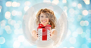 Happy woman with angel wings and christmas gift