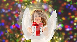 Happy woman with angel wings and christmas gift
