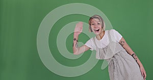 Happy woman appearing greeting hello and disappearing on green screen