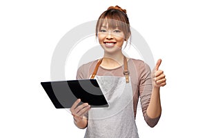 happy woman in apron with tablet pc computer