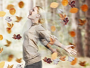 Happy Woman With Arms Outstretched Amid Fall Leaves