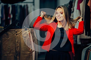 Happy Woman Arranging her Bouncy Hair Wearing red Blazer