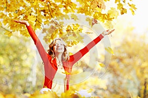 Happy woman in autumn park