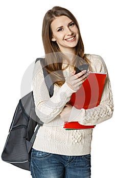 Happy woman with backpack and books with cell phone