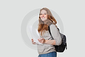 Happy woman with backpack standing against white studio wall banner background