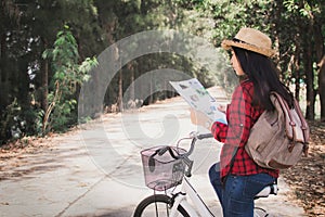 Happy woman backpacker with white bicycle