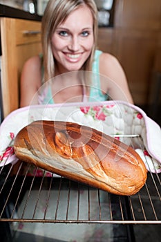 Happy woman baking bread