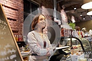 Happy woman or barmaid at cafe counter