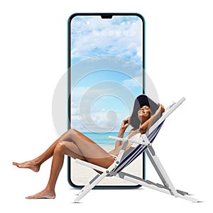 Happy woman at the beach on a beach deck chair, sunbathing, isolated with a mobile phone screen in the white background, concept a