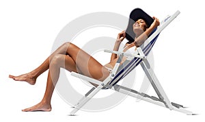 Happy woman at the beach on beach deck chair, sunbathing, wearing sun hat, isolated in the white background, concept a summer