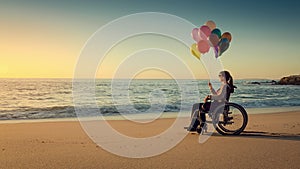 Happy woman on the beach holding ballons