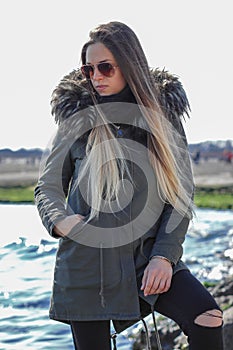 Happy woman. Beautiful blonde girl, model, walks near the sea. La Diga, Veneto, Italy photo