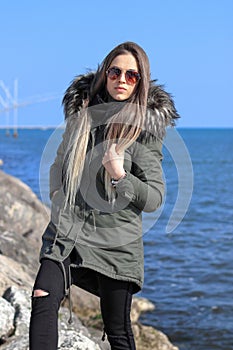 Happy woman. Beautiful blonde girl, model, walks near the sea. La Diga, Veneto, Italy