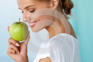 Happy Woman With Beautiful Smile, Healthy Teeth Holding Apple