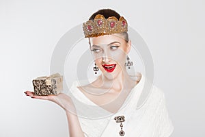 Happy woman beauty pageant contestant holding gift box