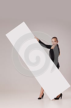 Happy woman behind blank copy space banner