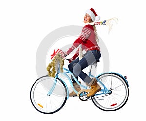 Happy woman on bicycle with christmas present.