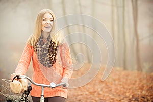 Happy woman with bike bicycle in autumn park