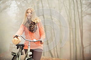 Happy woman with bike bicycle in autumn park.