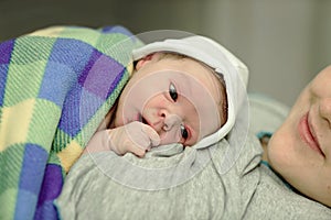 Happy woman after birth with a newborn baby