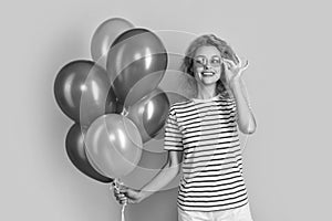 happy woman with birthday balloon in sunglasses. happy birthday woman hold party balloons