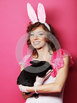 Happy woman with black rabbit