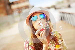 Happy woman blowing soap bubbles