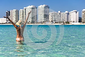 Happy woman on blue seagull beach in Cancun city in Riviera Mayan Mexico. Turquoise caribbean beach.