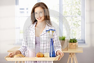 Happy woman with breakfast tray