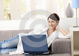 Happy woman browsing internet photo