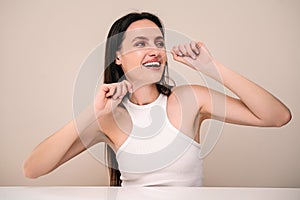 Happy woman brushing her healthy teeth using dental floss