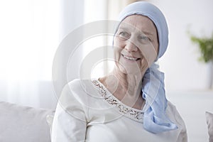 Happy woman in cancer headscarf