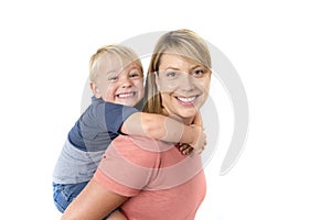 Happy woman carrying her adorable 3 years old little boy on her back smiling happy and cheerful in family mother and son together