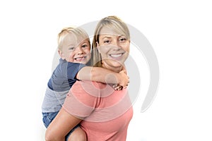 Happy woman carrying her adorable 3 years old little boy on her back smiling happy and cheerful in family mother and son together