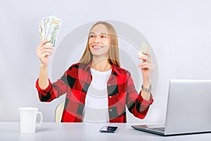 Happy woman and cash back. Portrait smiling woman with credit cards in one hand and cash