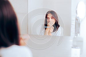 Happy Woman Checking Pregnancy Test in the Bathroom