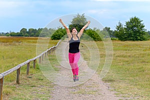 Happy woman cheering and celebrating after working out jogging