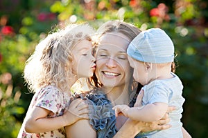 Happy woman with child and baby