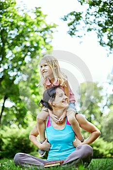 Happy woman and child in the blooming spring garden.Mothers day holiday concept