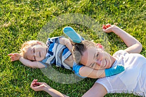 Happy woman and child having fun outdoor on meadow