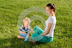 Happy woman and child having fun outdoor on meadow